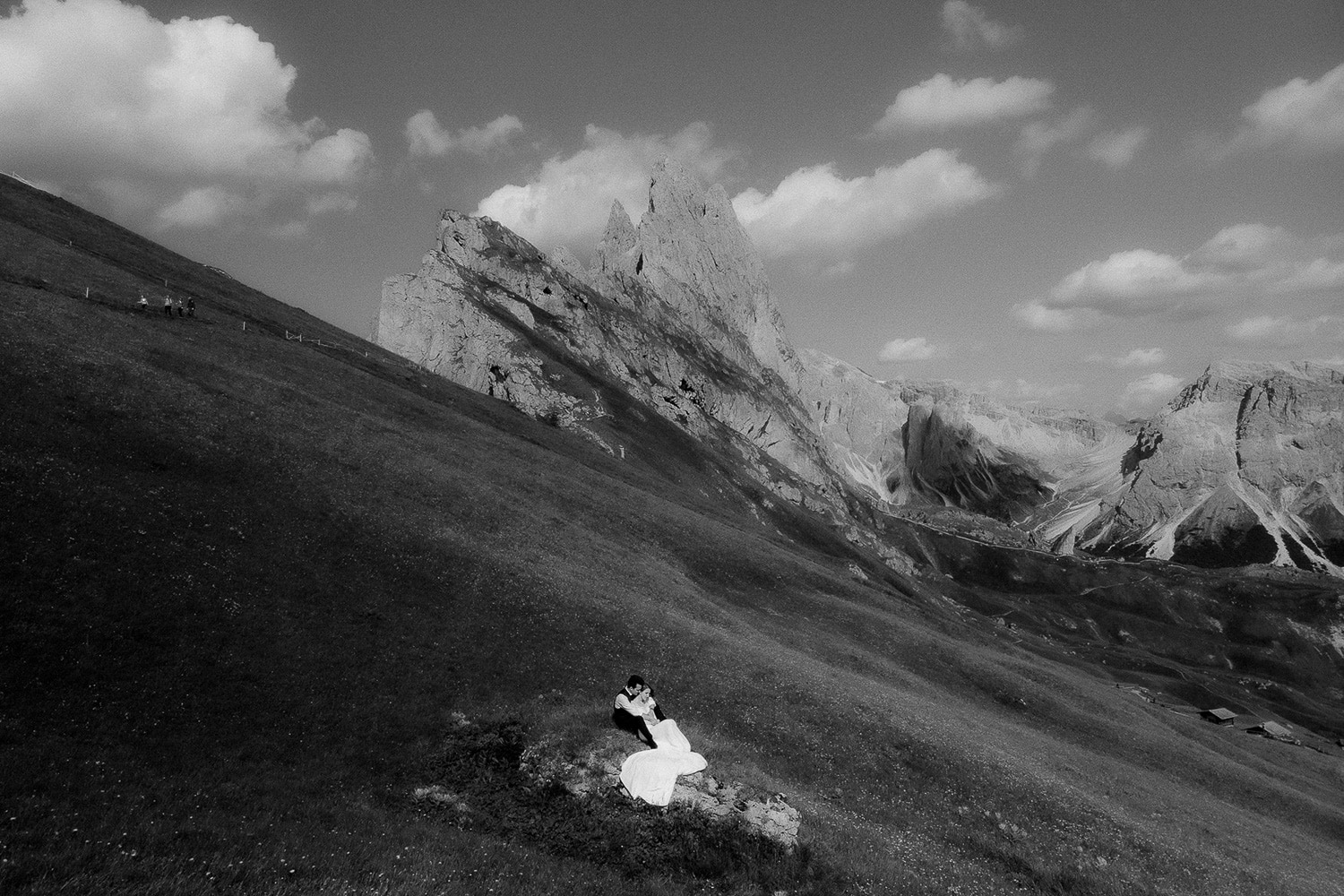 Bride and groom sitting on a rock at Seceda in the Dolomites during Italy Elopement 
